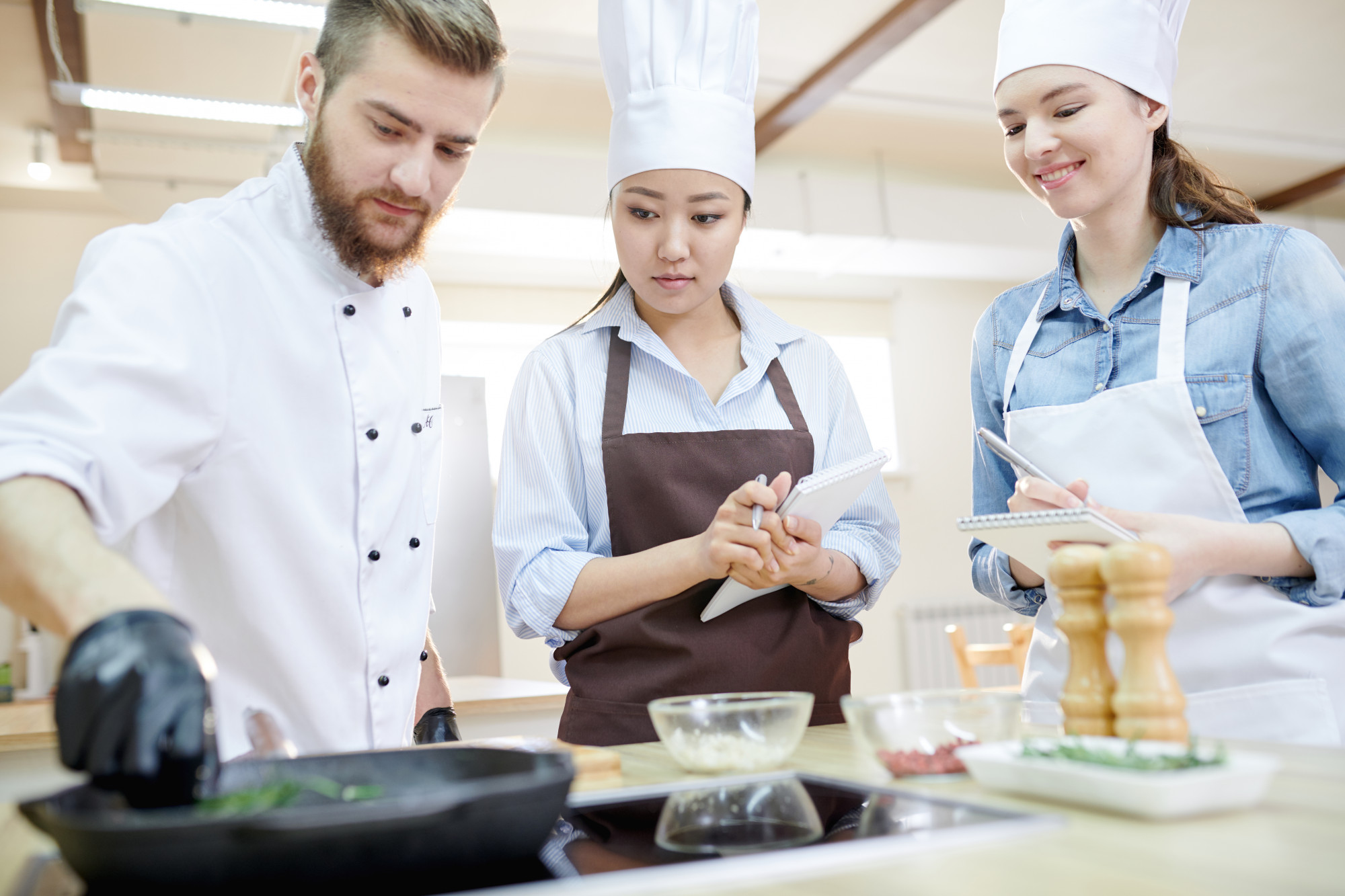 Chef demonstrating technique to students
